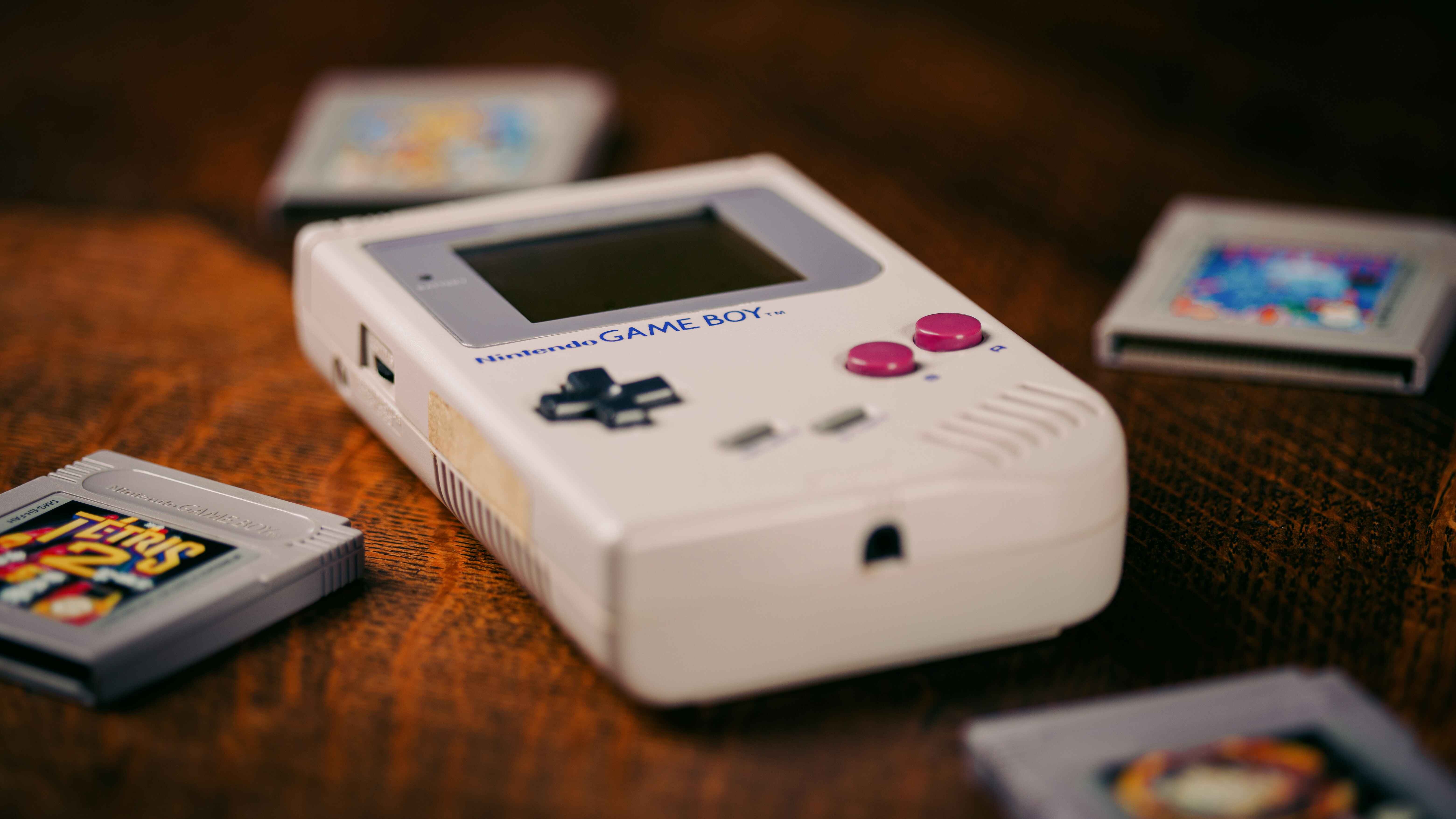 An old Game Boy System with old games around it